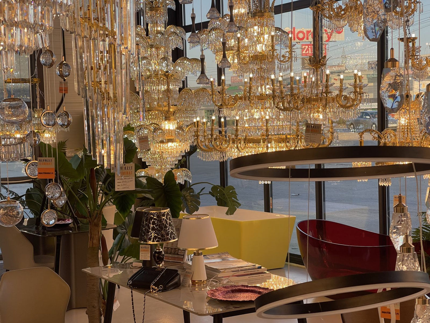 Dozens of crystal chandeliers lit in the Alessandro Design showroom in Afumați