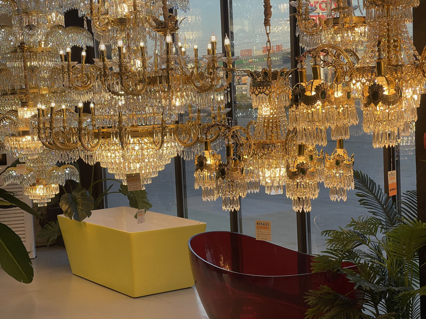 Dozens of crystal chandeliers lit in the Alessandro Design showroom in Afumați